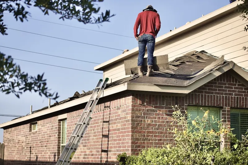Professional roofer working on a residential roof in River Island